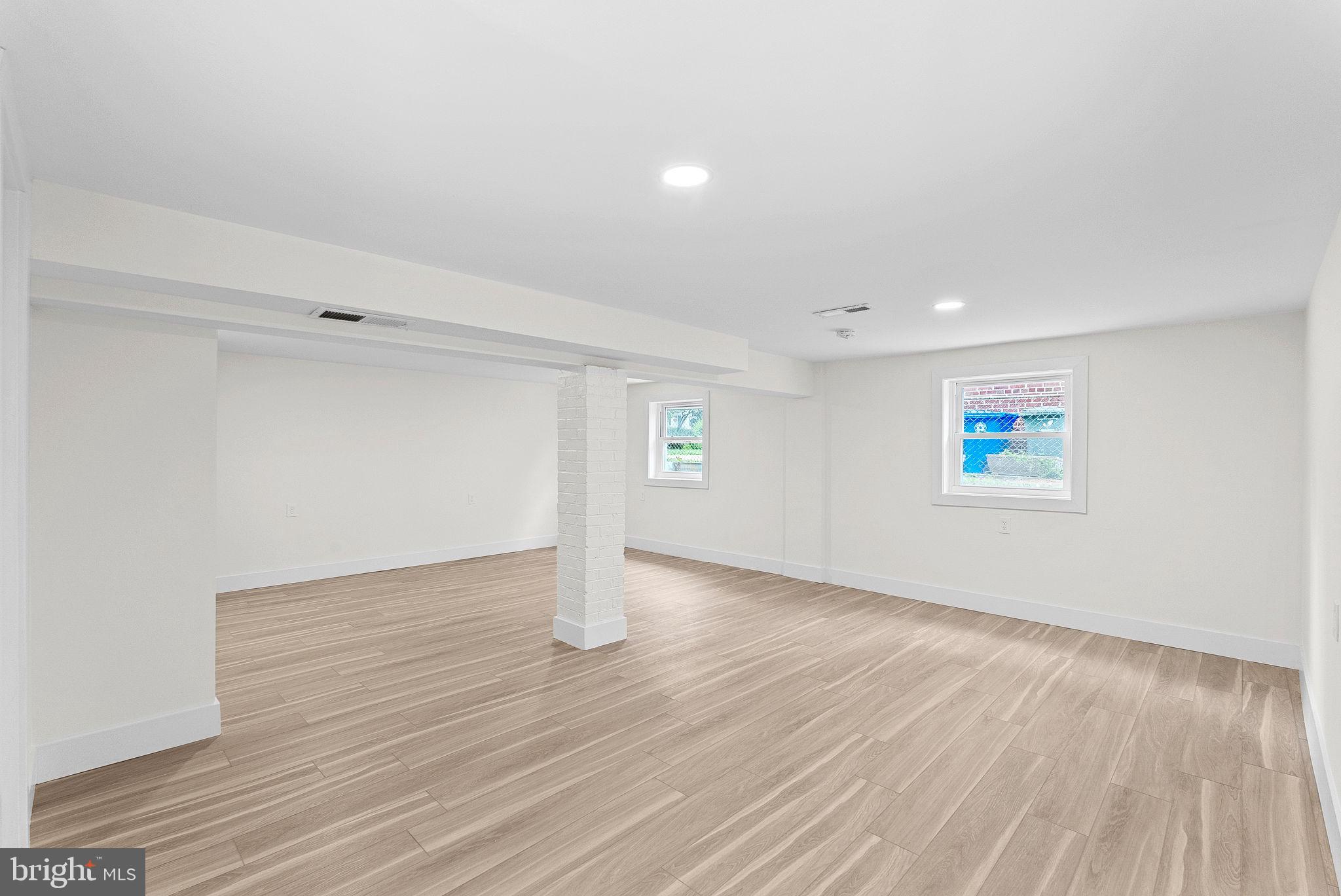 1805 South Pollard Street Arlington, VA 22204 - Photo 51 of 55 an empty room with wooden floor and windows