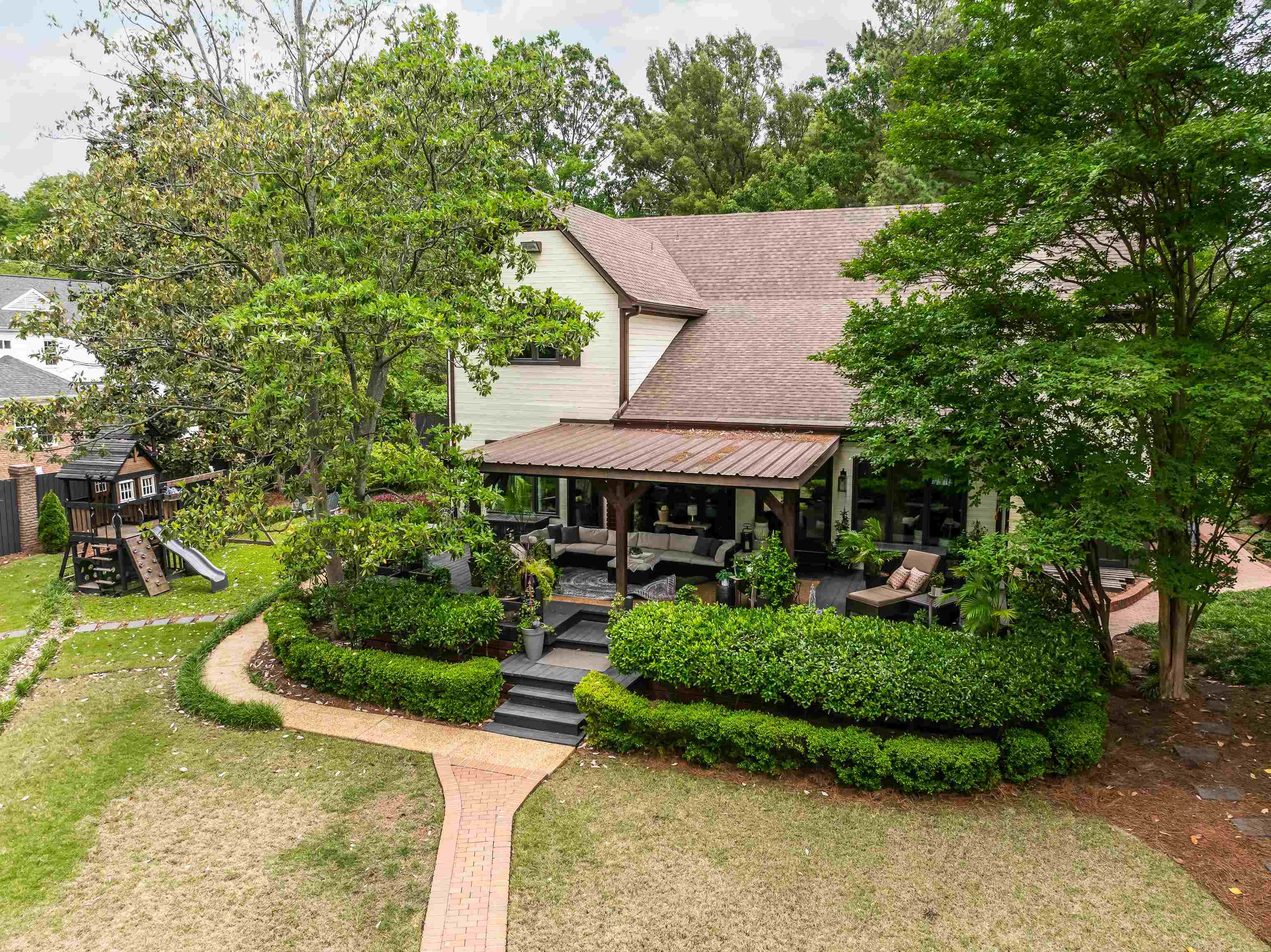 811 Sweetbrier Road Memphis, TN 38120 - Photo 36 of 40 Spacious exterior patio featuring a metal roof, dark-stained wood columns, and multiple seating areas