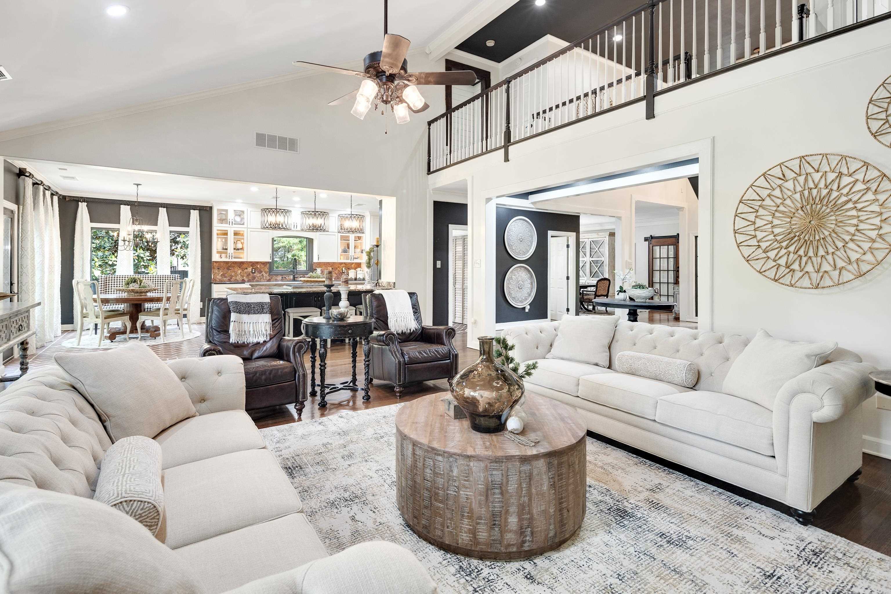 811 Sweetbrier Road Memphis, TN 38120 - Photo 9 of 40 Expansive living space featuring a vaulted ceiling and dark wood-finish flooring