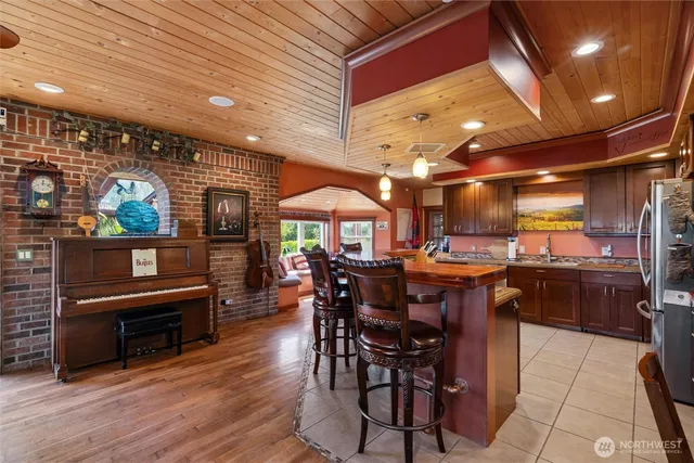 a spacious bedroom with a large bed a flat tv screen and dresser