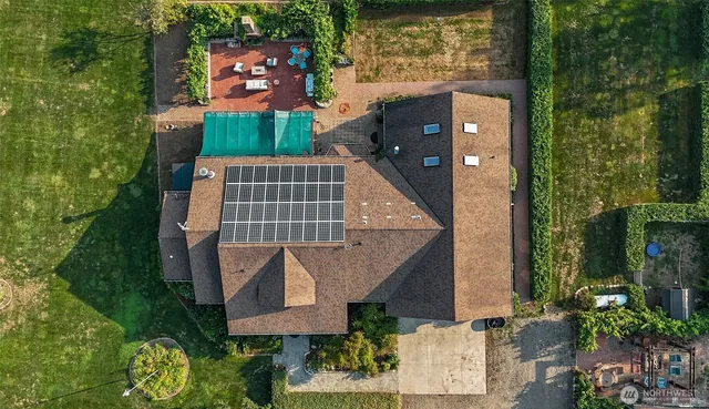 an aerial view of a house with a yard and potted plants