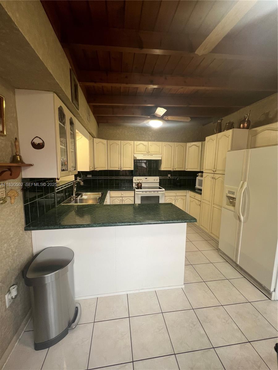 2815 Southwest 36th Avenue Miami, FL 33133 - Photo 12 of 25 a view of a kitchen with stainless steel appliances granite countertop a sink and a stove