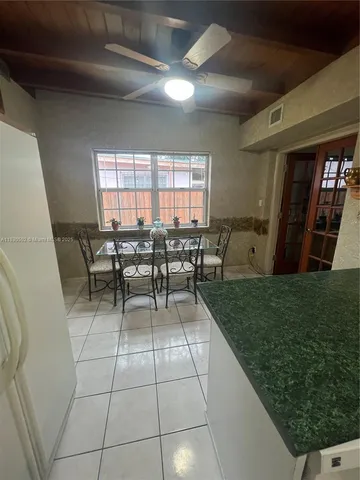 a view of a patio with table and chairs