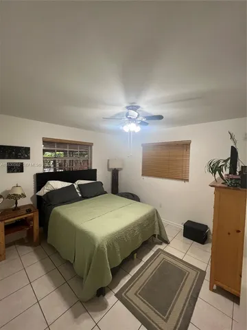 a bedroom with double bed and a window