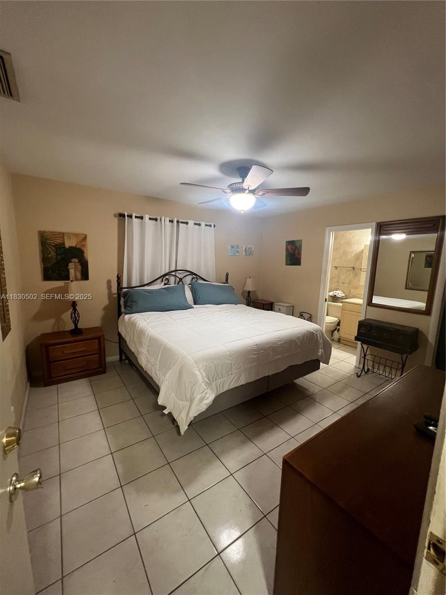 2815 Southwest 36th Avenue Miami, FL 33133 - Photo 19 of 25 a bedroom with a bed and a view of kitchen