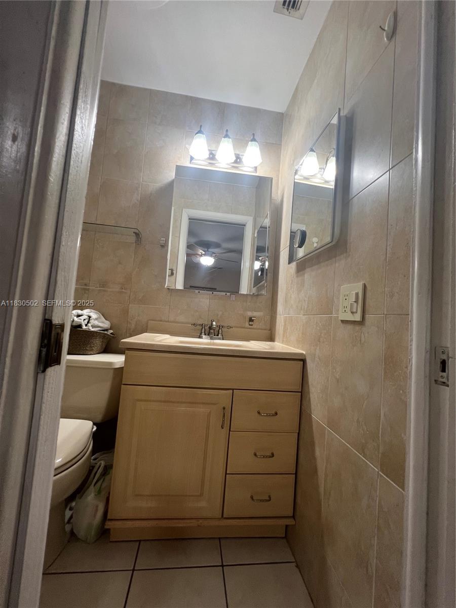 2815 Southwest 36th Avenue Miami, FL 33133 - Photo 21 of 25 a bathroom with a sink a toilet and mirror