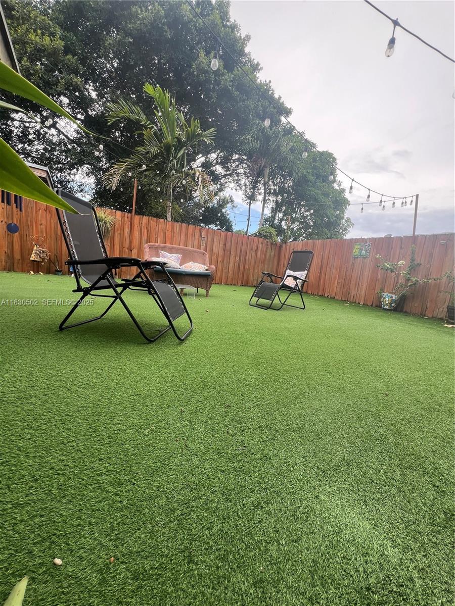 2815 Southwest 36th Avenue Miami, FL 33133 - Photo 22 of 25 a backyard of a house with table and chairs