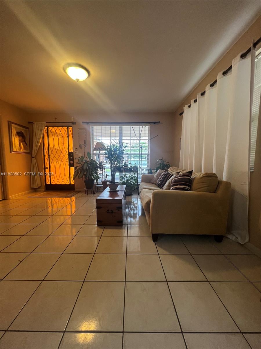 2815 Southwest 36th Avenue Miami, FL 33133 - Photo 6 of 25 a living room with furniture and a floor to ceiling window