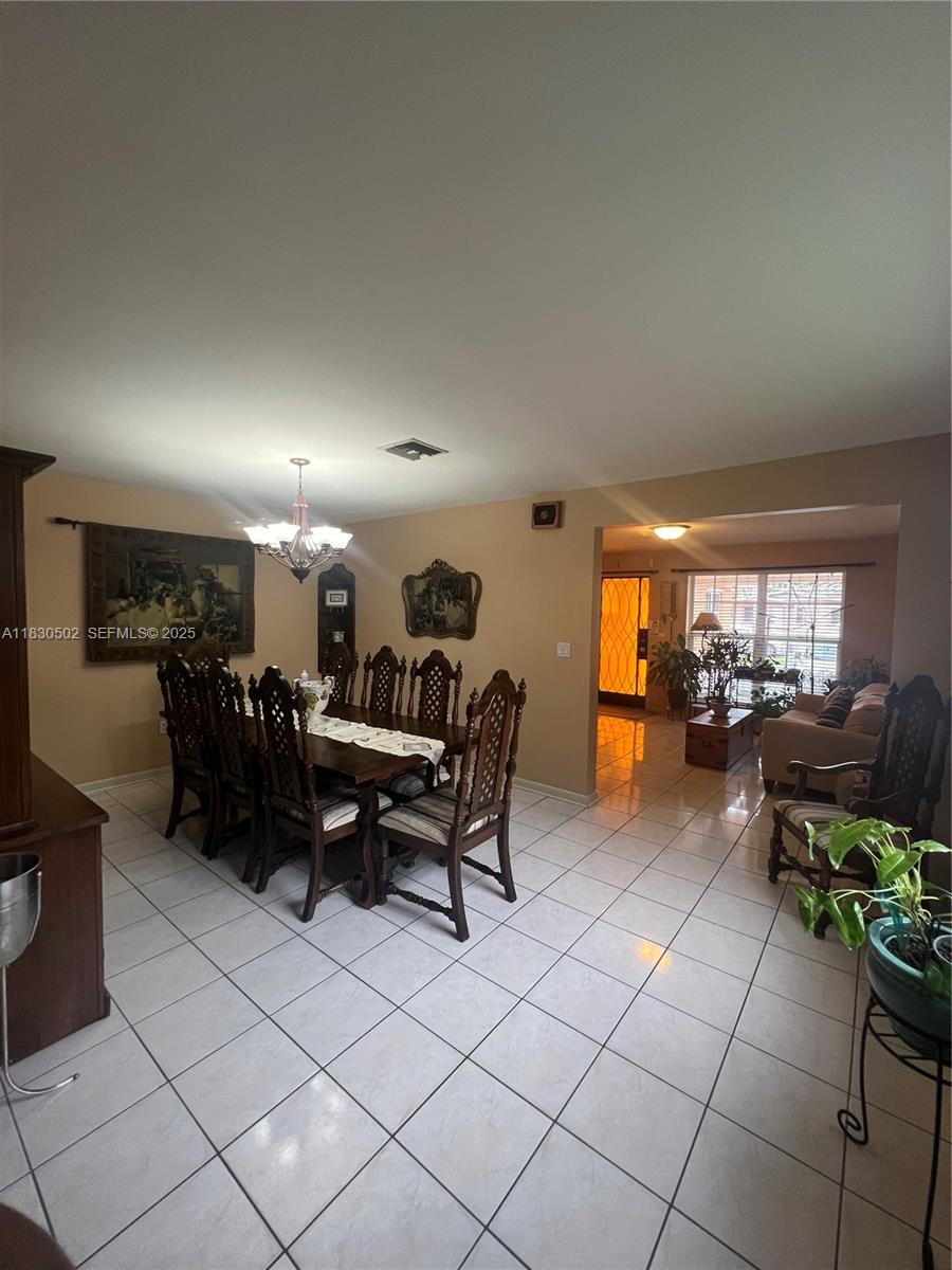 2815 Southwest 36th Avenue Miami, FL 33133 - Photo 9 of 25 a living room with furniture a large window and a table