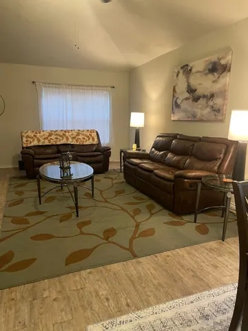 a living room with furniture and a rug