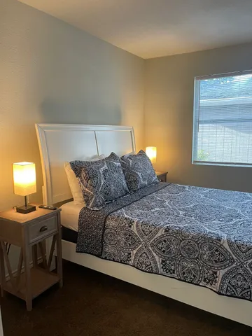 a bedroom with a bed and a window