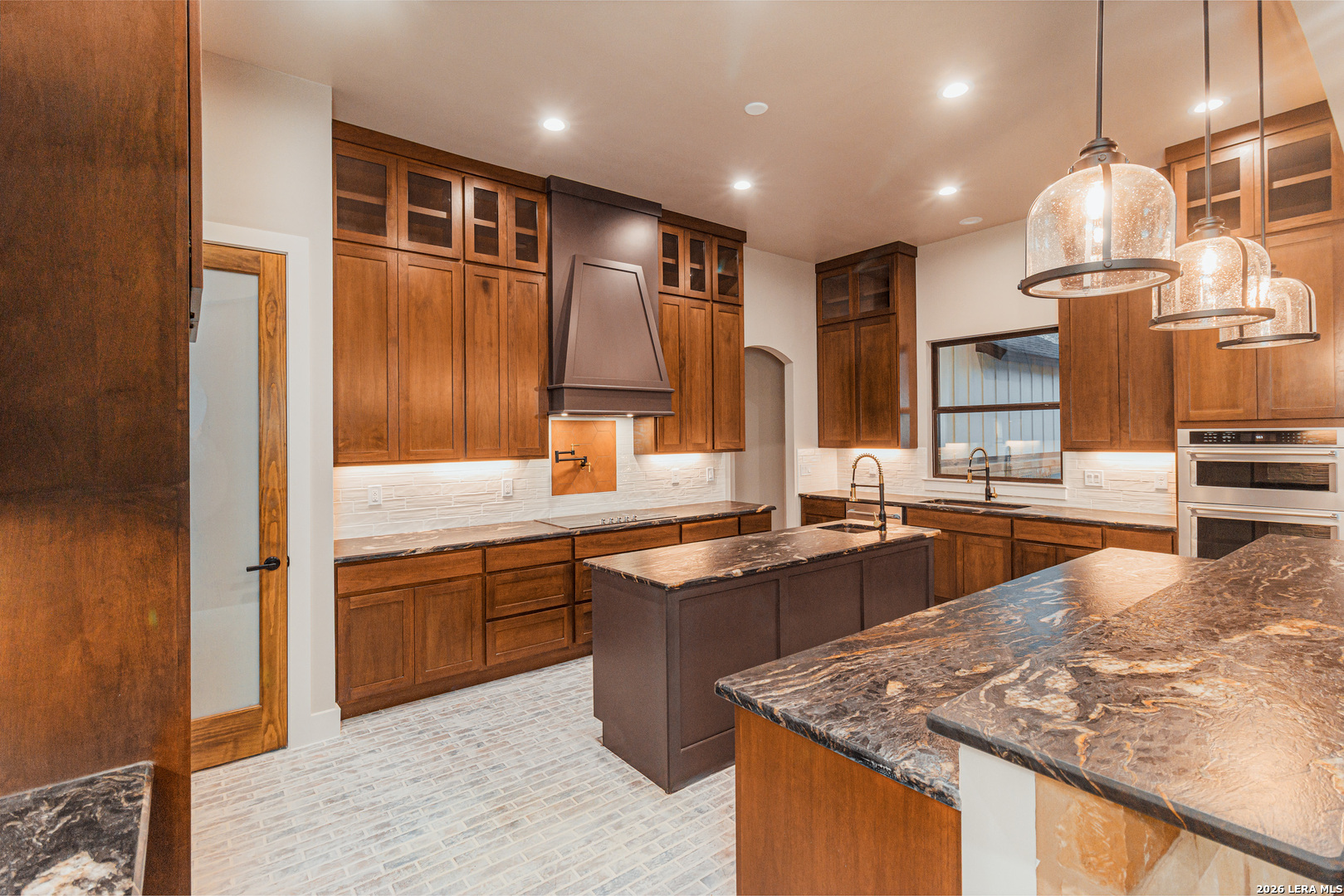 176 Hondo Ridge La Vernia, TX 78121 - Photo 11 of 28 a kitchen with stainless steel appliances granite countertop sink stove and refrigerator