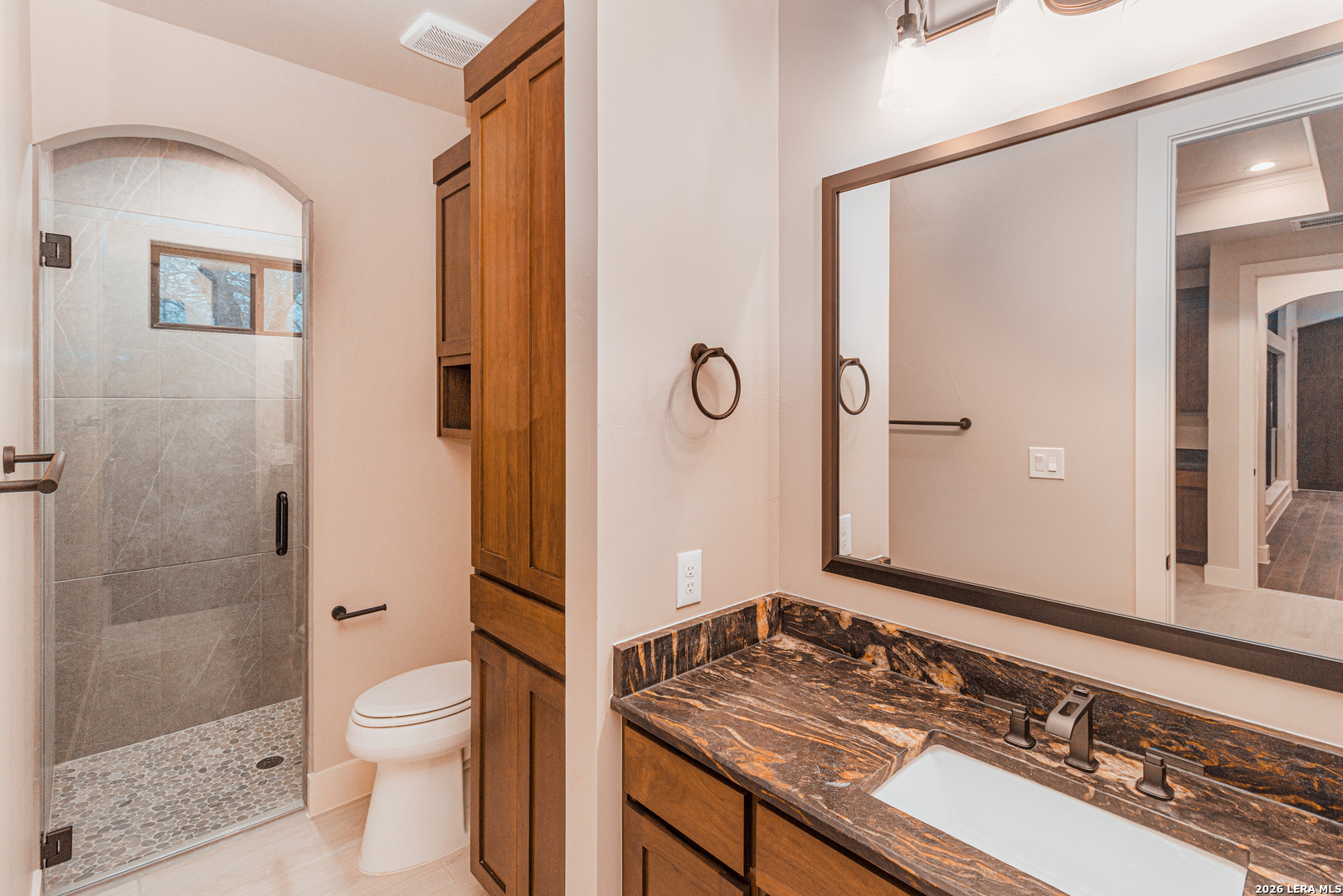 176 Hondo Ridge La Vernia, TX 78121 - Photo 14 of 28 a bathroom with a granite countertop sink toilet and shower