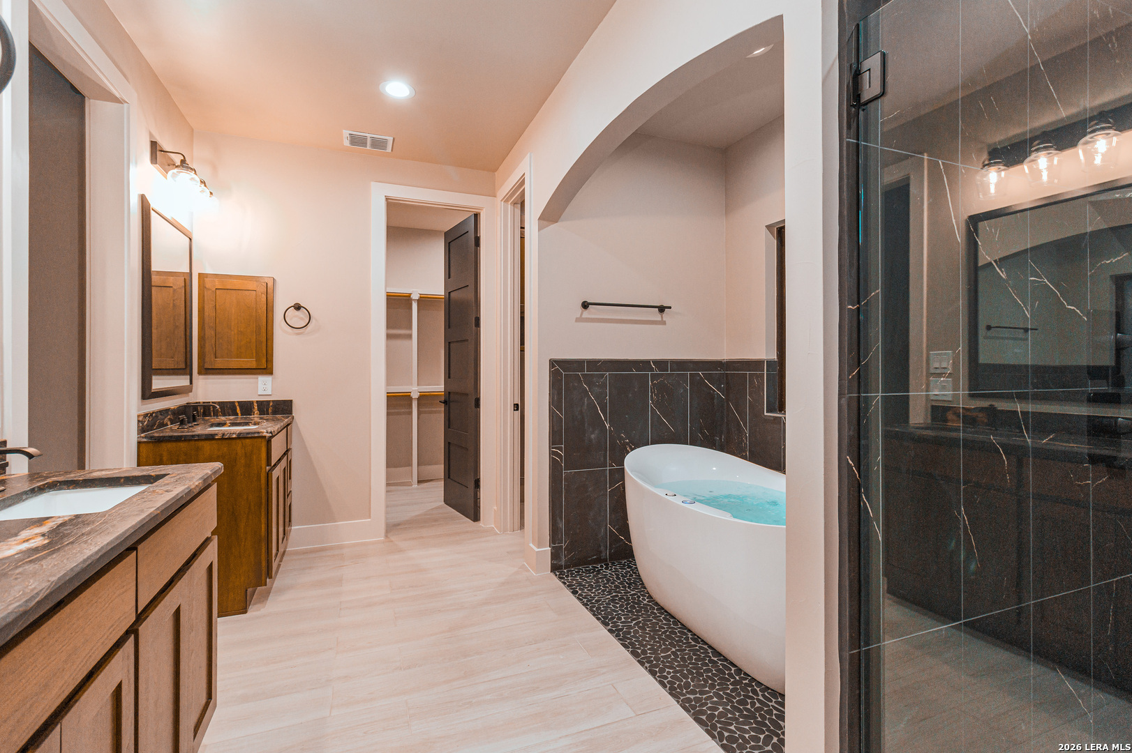 176 Hondo Ridge La Vernia, TX 78121 - Photo 21 of 28 a spacious bathroom with a sink a mirror and a bathtub