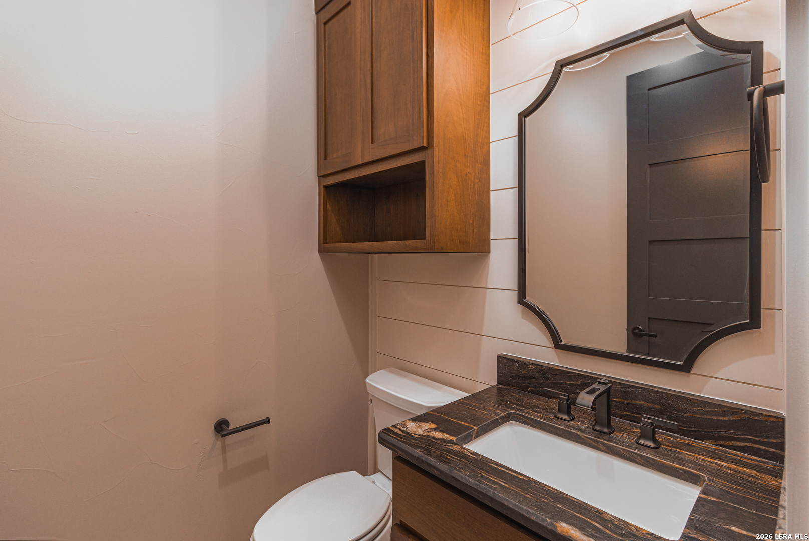176 Hondo Ridge La Vernia, TX 78121 - Photo 25 of 28 a bathroom with a granite countertop toilet sink and mirror