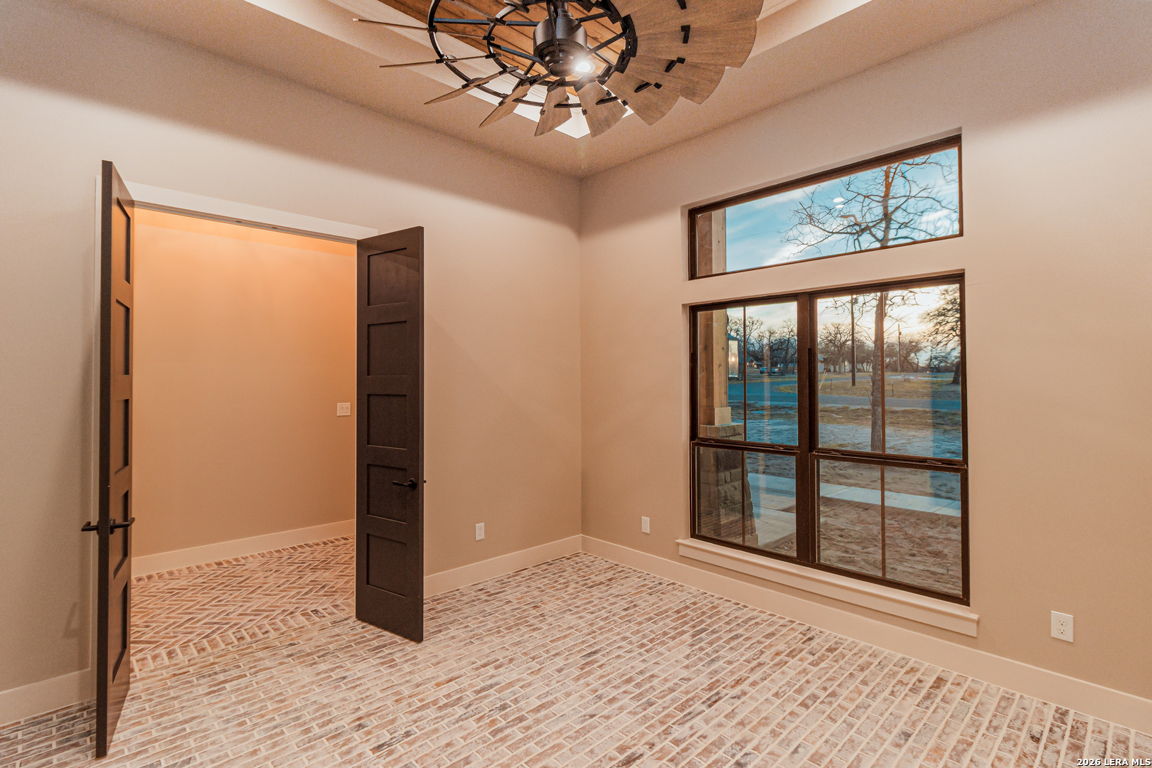 176 Hondo Ridge La Vernia, TX 78121 - Photo 6 of 28 an empty room with chandelier fan and windows