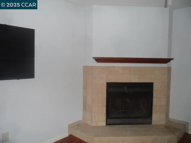 a room with a fireplace and a wooden floor