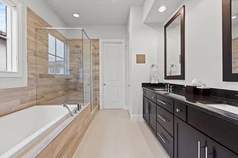 a bathroom with a double vanity sink and mirror