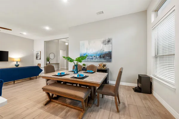 a large white kitchen with a large island in the center