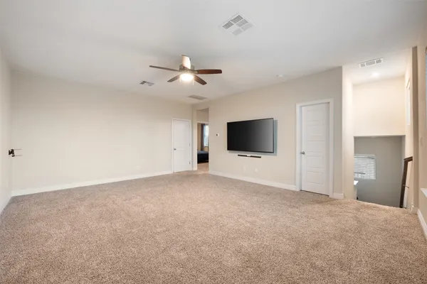 a view of an empty room with a fireplace and a window