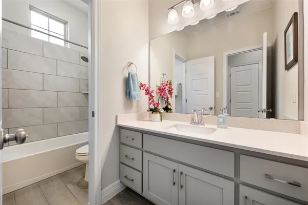 a bed sitting in a spacious bedroom next to a window