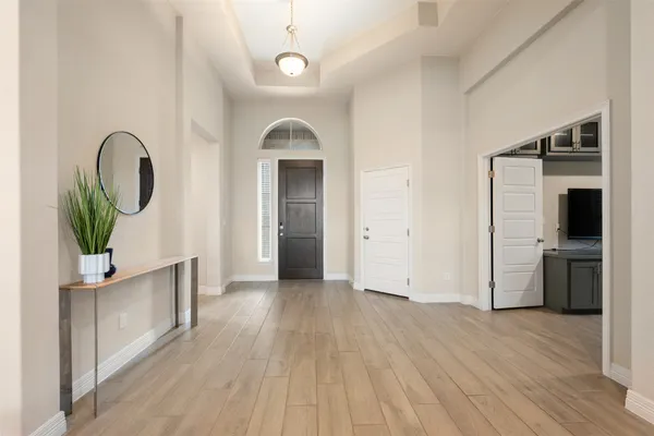 a view of empty room with wooden floor and window