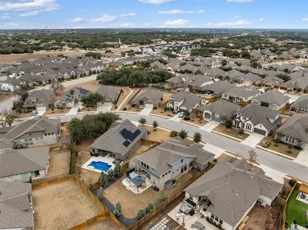 an aerial view of a house with a yard