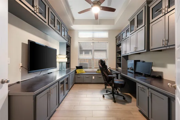 a view of a workspace with furniture and a window