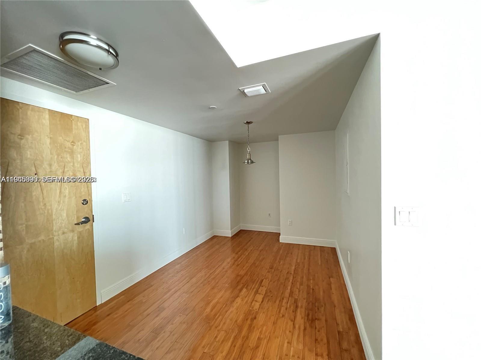 350 South Miami Avenue, Unit 1905 Miami, FL 33130 - Photo 4 of 26 a view of a room with wooden floor and bathroom