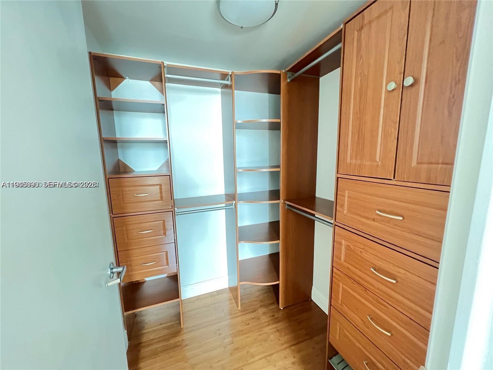 350 South Miami Avenue, Unit 1905 Miami, FL 33130 - Photo 8 of 26 a room with walk in closet and wooden floor