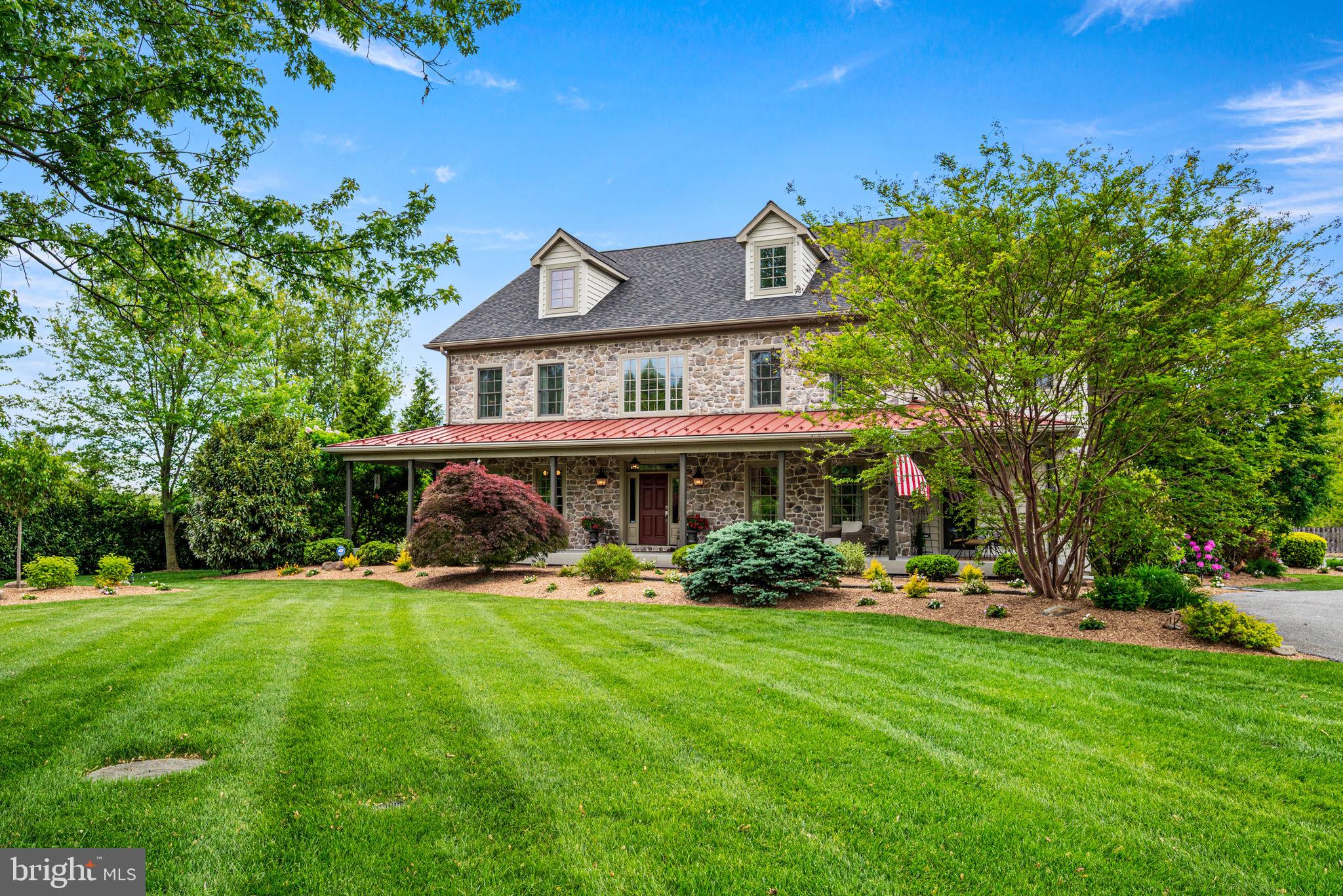 1548 Morstein Road Malvern, PA 19355 - Photo 3 of 80 a front view of a house with a garden and trees
