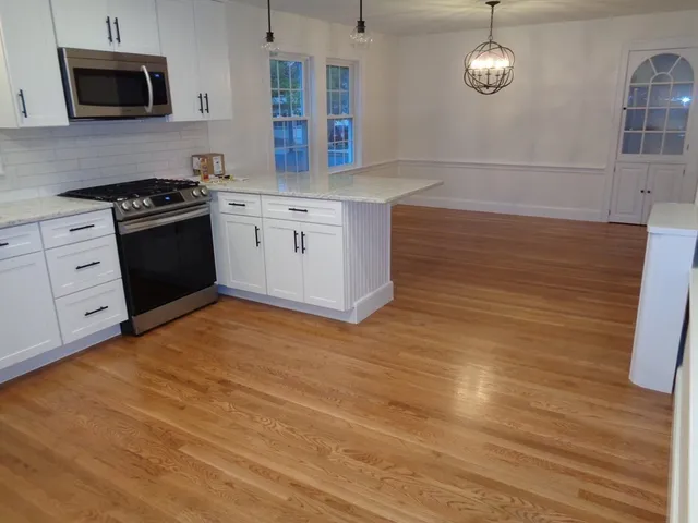 a kitchen with stainless steel appliances a stove microwave and cabinets