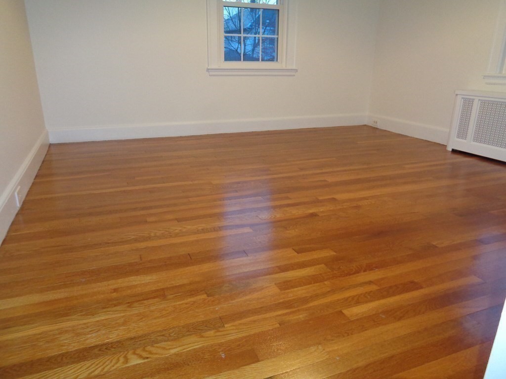 60 Payson Road, Unit 1 Belmont, MA 02478 - Photo 7 of 13 a view of empty room with wooden floor and fan