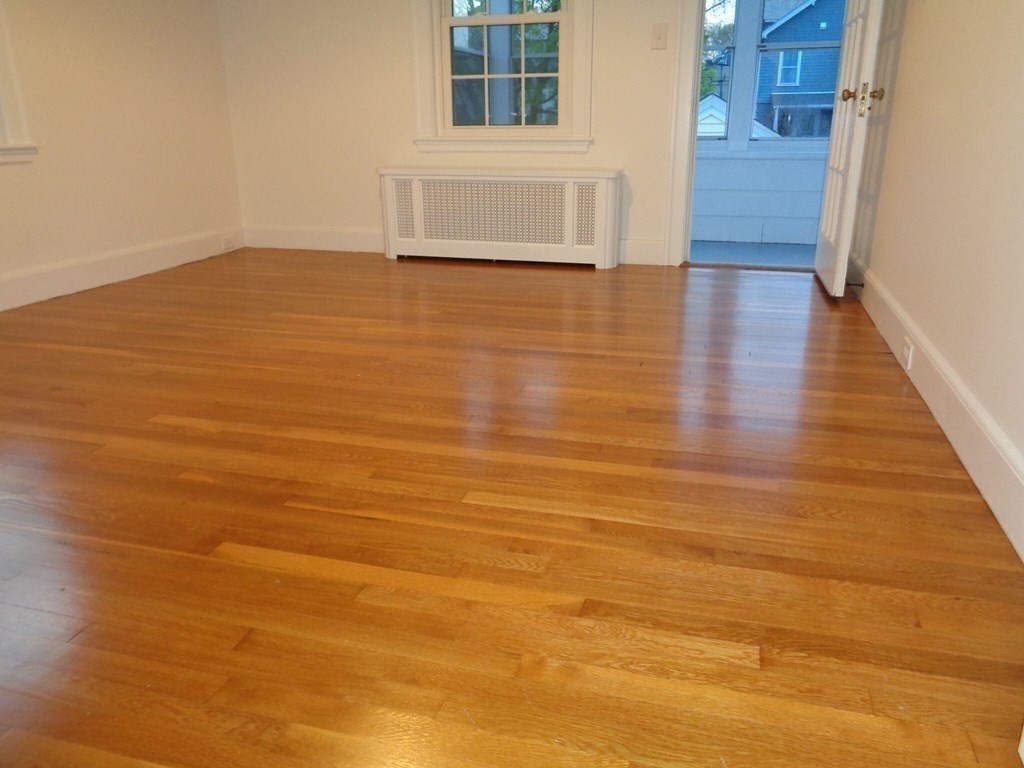 60 Payson Road, Unit 1 Belmont, MA 02478 - Photo 8 of 13 a view of an empty room with wooden floor and a window