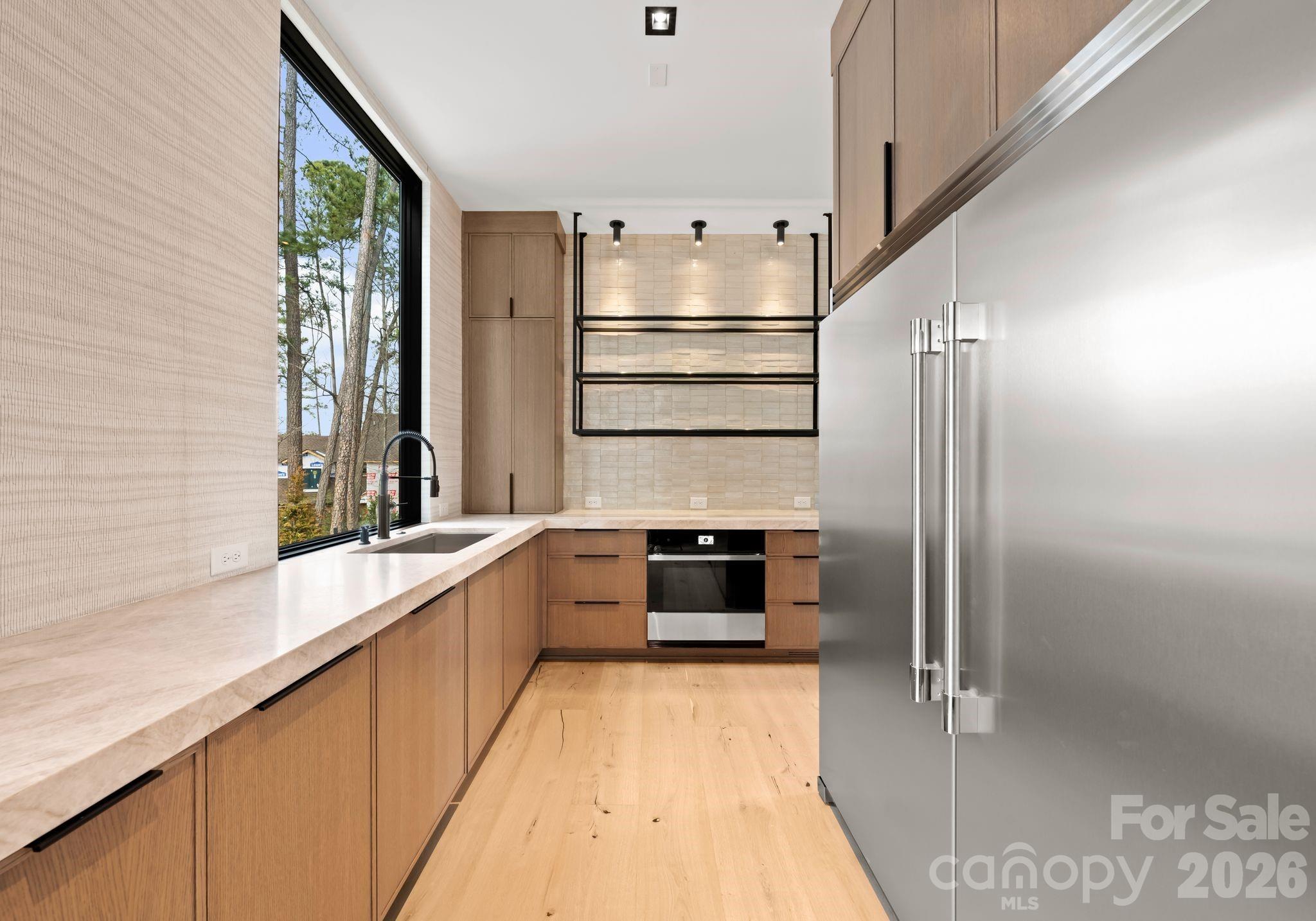 2536 Brawley School Road Mooresville, NC 28117 - Photo 14 of 48 a kitchen with stainless steel appliances a refrigerator sink and stove