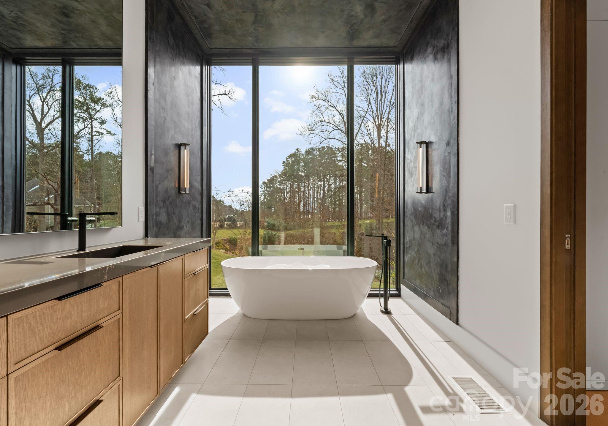 2536 Brawley School Road Mooresville, NC 28117 - Photo 24 of 48 a bathroom with a large tub and sink