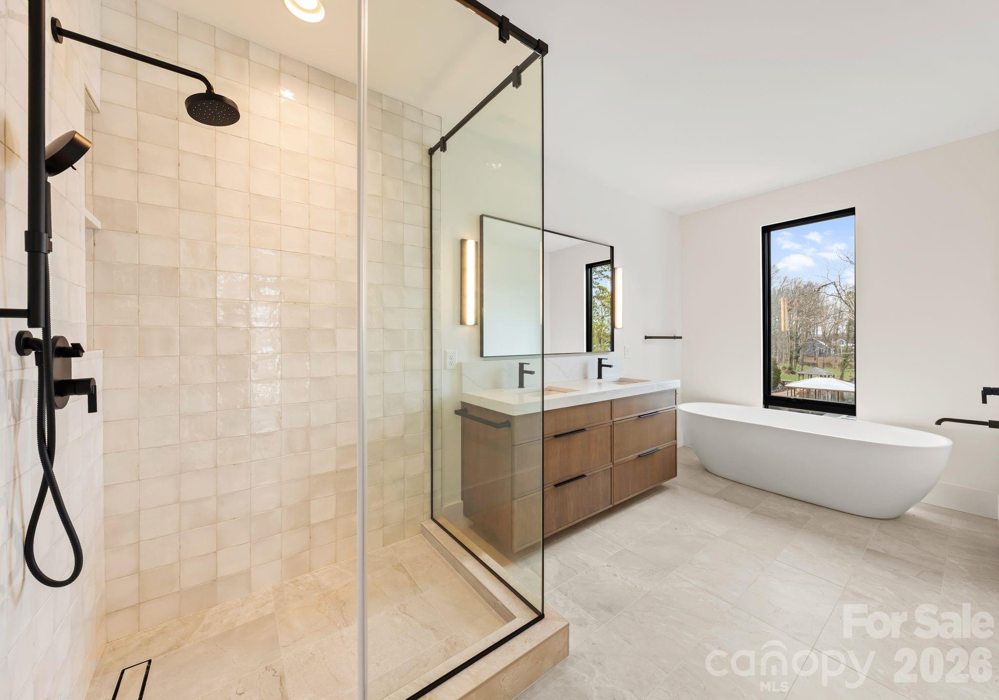2536 Brawley School Road Mooresville, NC 28117 - Photo 33 of 48 a bathroom with a bathtub sink mirror vanity and toilet