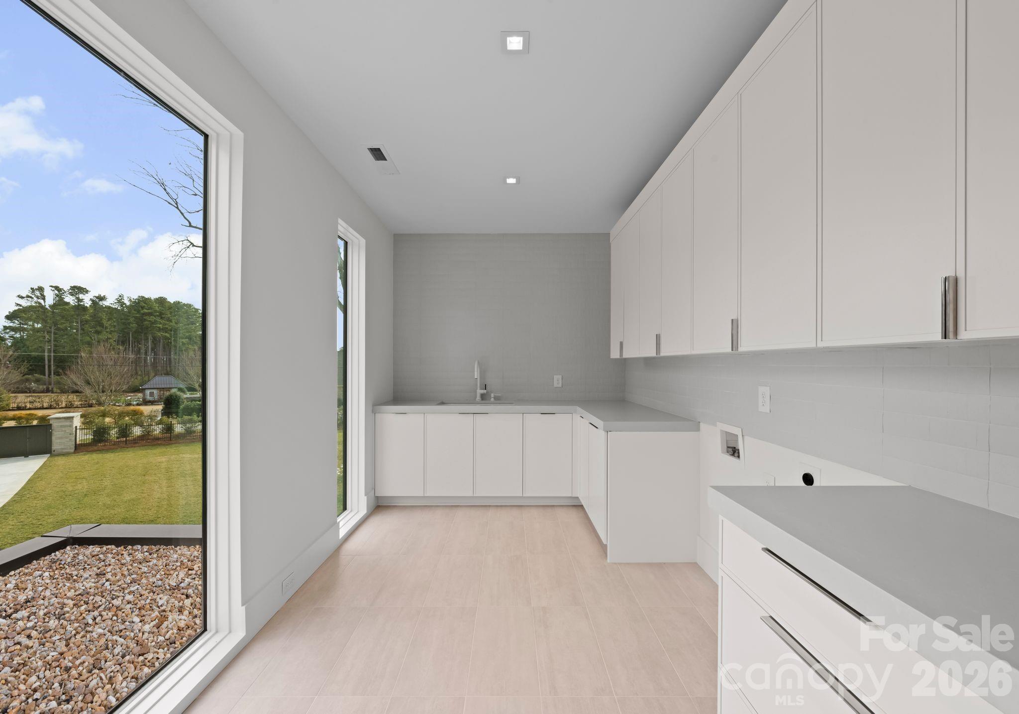 2536 Brawley School Road Mooresville, NC 28117 - Photo 35 of 48 a view of a kitchen with kitchen island and windows