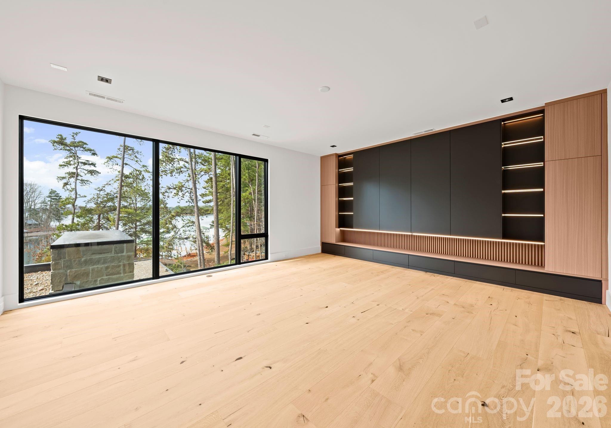 2536 Brawley School Road Mooresville, NC 28117 - Photo 39 of 48 a view of an empty room with a fireplace and a large window