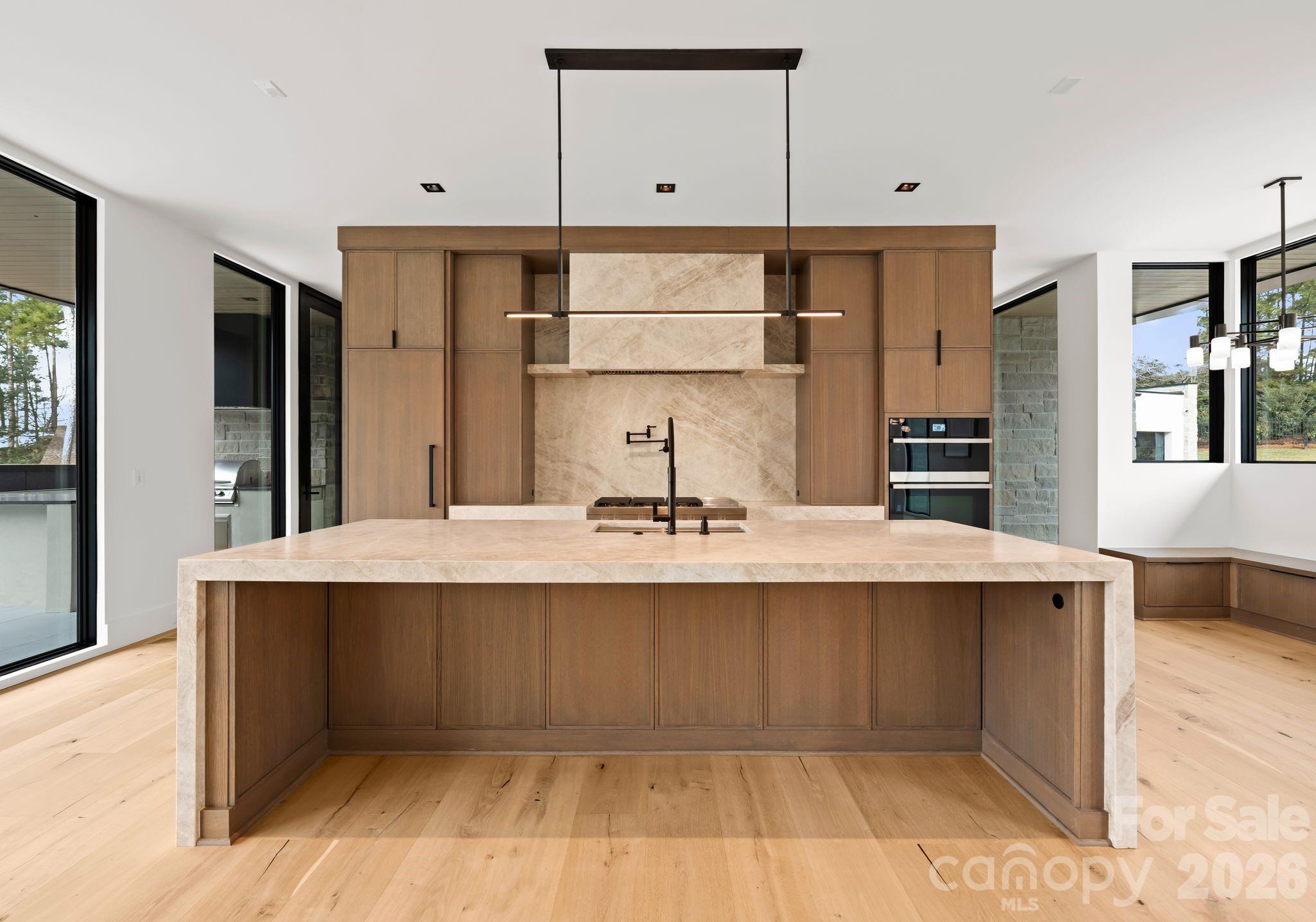 2536 Brawley School Road Mooresville, NC 28117 - Photo 8 of 48 a large kitchen with kitchen island a sink stainless steel appliances and cabinets
