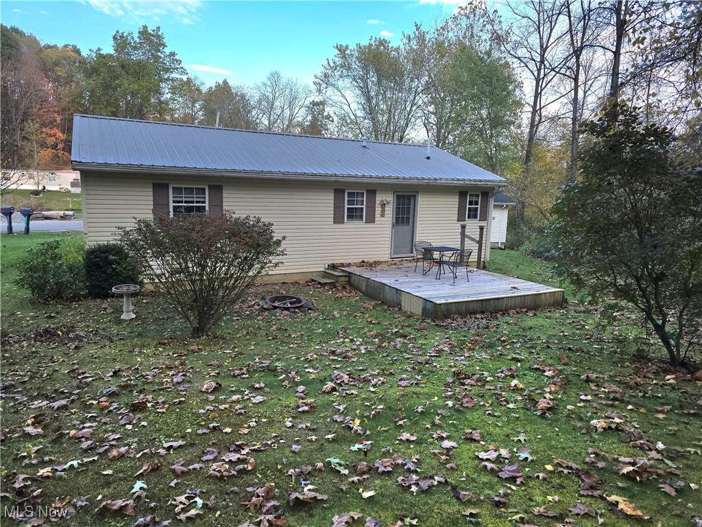 8019 Kroft Road Mount Perry, OH 43760 - Photo 6 of 41 Rear view of house with a yard, a deck, and a metal roof