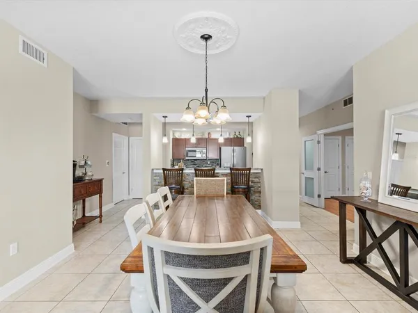 a living room with furniture a ceiling fan and a window