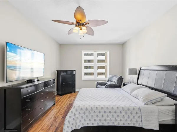 a bedroom with two beds and a flat screen tv