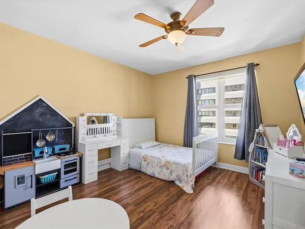 a view of a patio with dining table and chairs with a barbeque grill and large trees