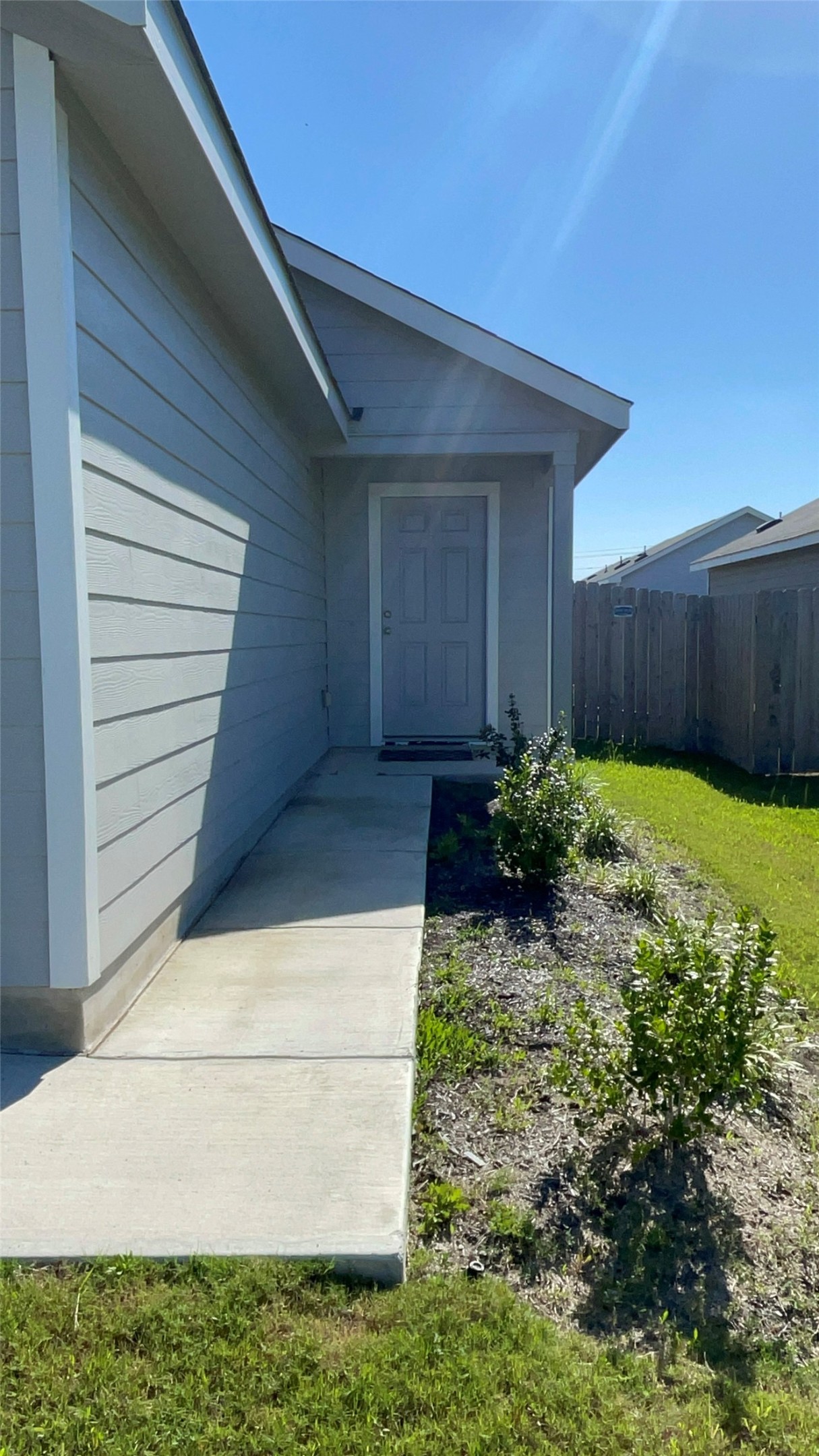 212 Marty Allen Loop Jarrell, TX 76537 - Photo 2 of 13 Exterior entry featuring horizontal siding, a covered porch, and a concrete walkway