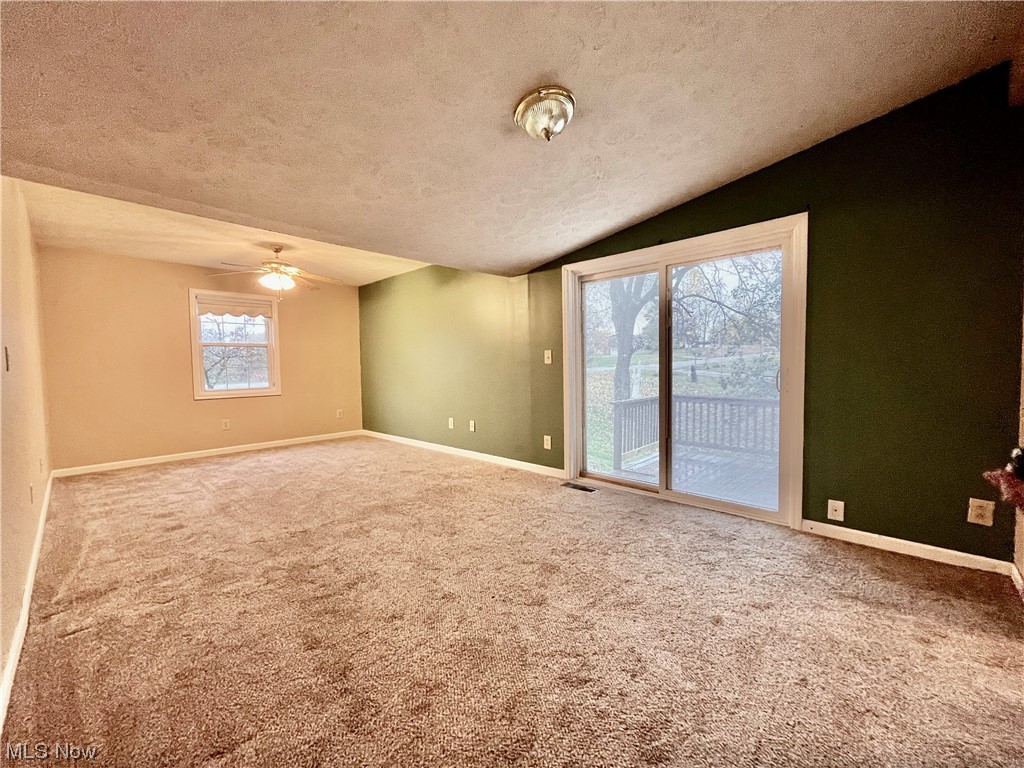4214 School House Road Little Hocking, OH 45742 - Photo 14 of 29 Carpeted empty room with a textured ceiling, ceiling fan, and vaulted ceiling