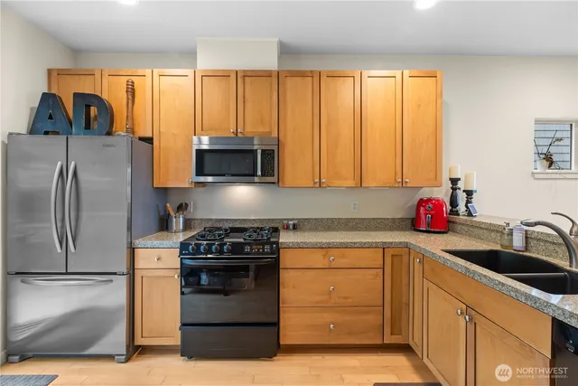 a kitchen with a sink stove and refrigerator