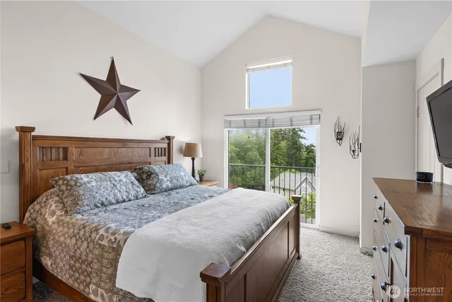 a bedroom with a bed a window and a potted plant