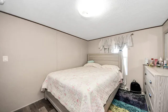 a bedroom with a bed and a dresser