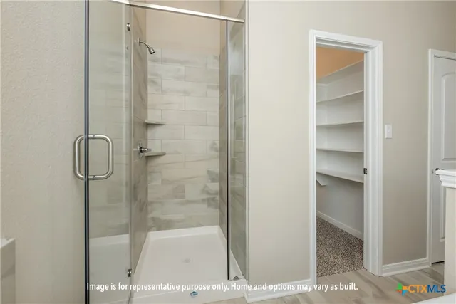 a bathroom with a glass shower door